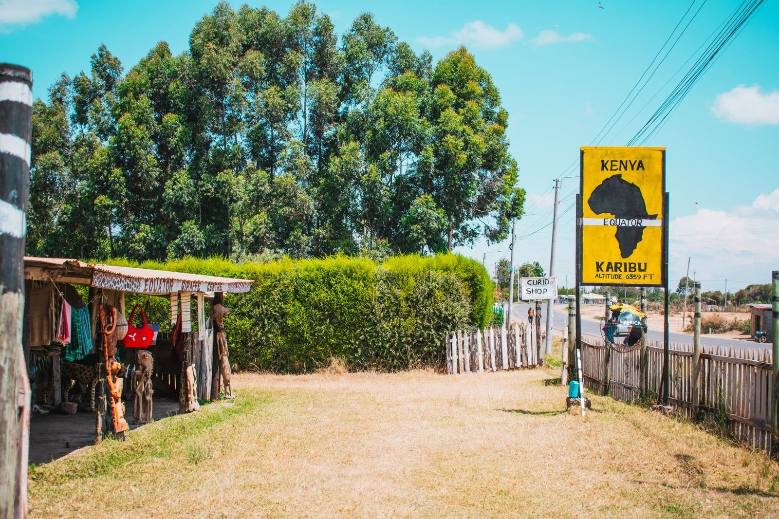 A roadside equator landmark sign and souvenir shop in Nanyuki near Mount Kenya.